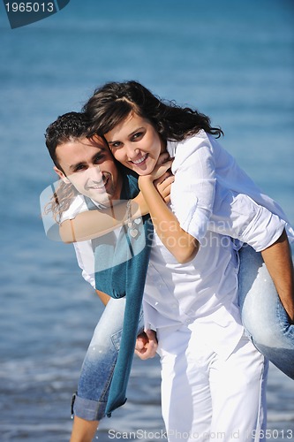 Image of happy young couple have fun at beautiful beach