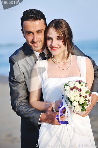 Image of romantic beach wedding at sunset