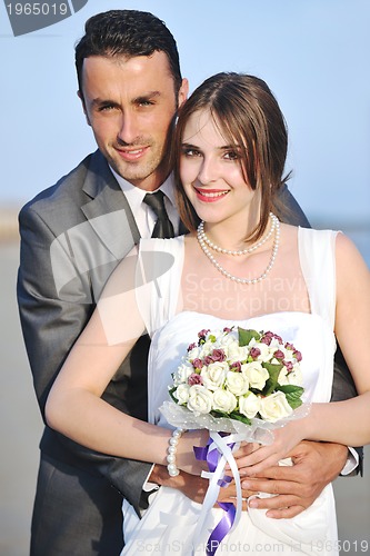 Image of romantic beach wedding at sunset