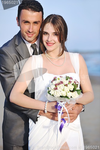 Image of romantic beach wedding at sunset