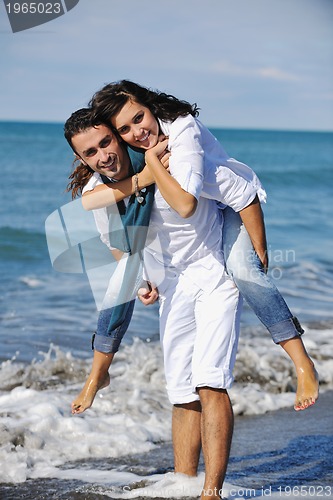 Image of happy young couple have fun at beautiful beach