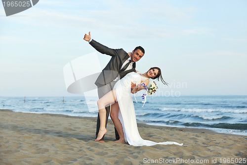 Image of romantic beach wedding at sunset