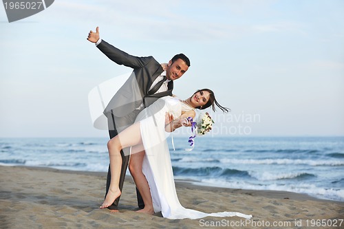 Image of romantic beach wedding at sunset