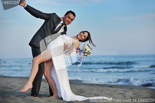Image of romantic beach wedding at sunset