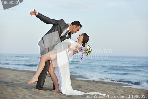 Image of romantic beach wedding at sunset