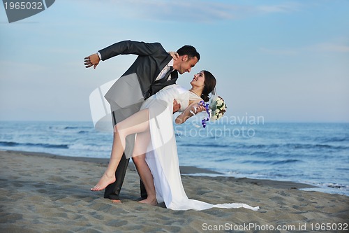Image of romantic beach wedding at sunset
