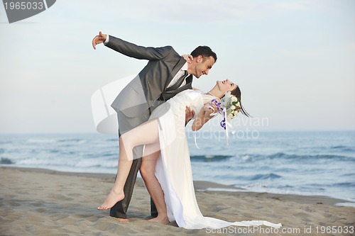 Image of romantic beach wedding at sunset