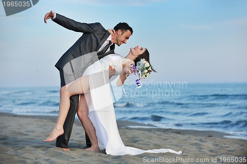 Image of romantic beach wedding at sunset