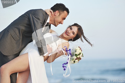 Image of romantic beach wedding at sunset