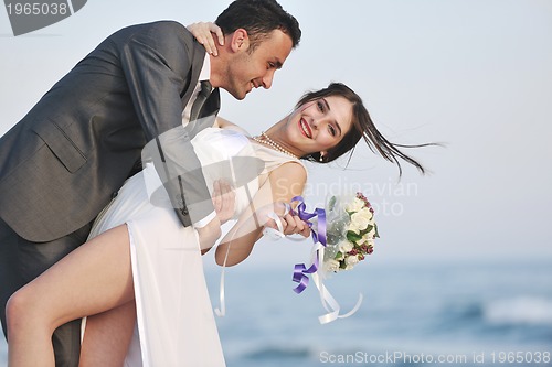 Image of romantic beach wedding at sunset