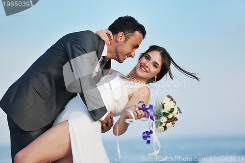 Image of romantic beach wedding at sunset