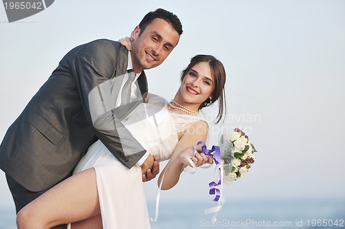Image of romantic beach wedding at sunset