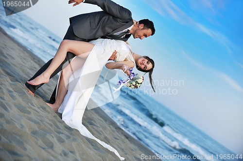 Image of romantic beach wedding at sunset