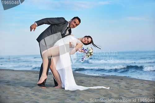 Image of romantic beach wedding at sunset