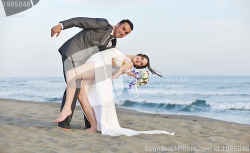 Image of romantic beach wedding at sunset