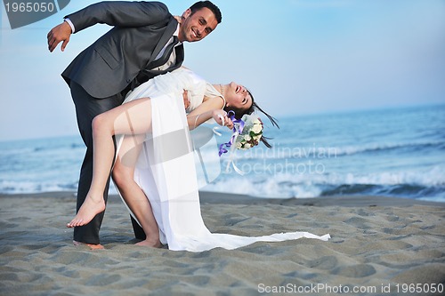 Image of romantic beach wedding at sunset