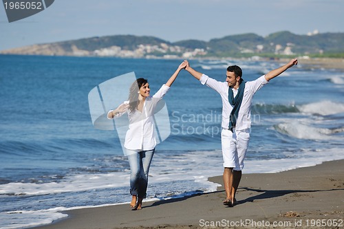 Image of happy young couple have fun at beautiful beach