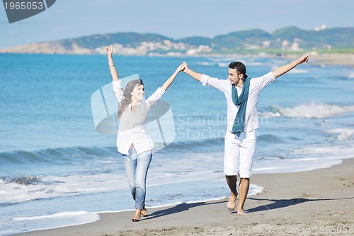 Image of happy young couple have fun at beautiful beach