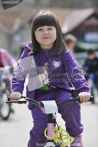 Image of happy childrens group learning to drive bicycle