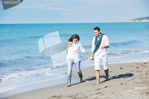 Image of happy young couple have fun at beautiful beach