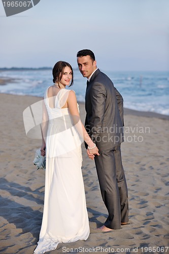 Image of romantic beach wedding at sunset