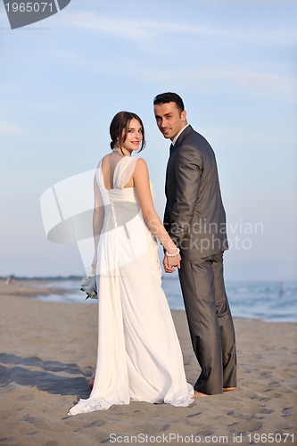 Image of romantic beach wedding at sunset