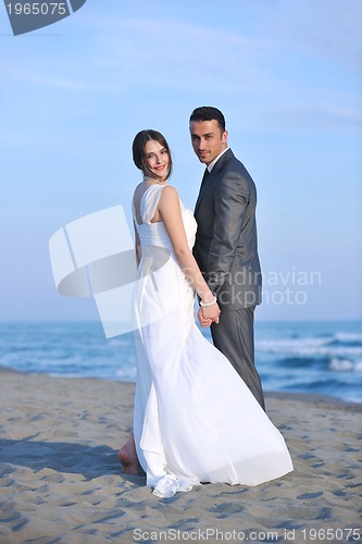 Image of romantic beach wedding at sunset