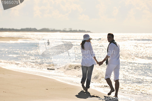 Image of happy young couple have fun at beautiful beach