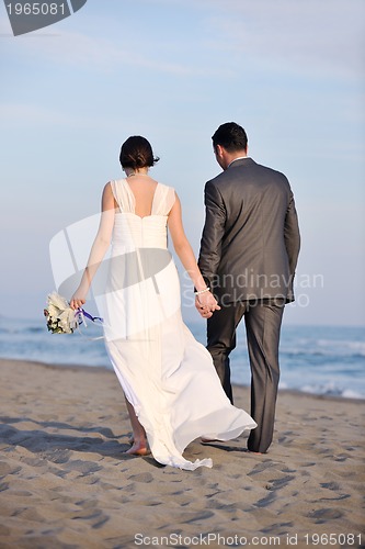 Image of romantic beach wedding at sunset