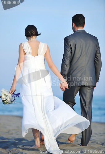 Image of romantic beach wedding at sunset
