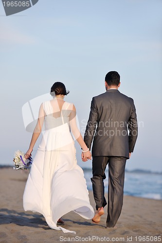 Image of romantic beach wedding at sunset