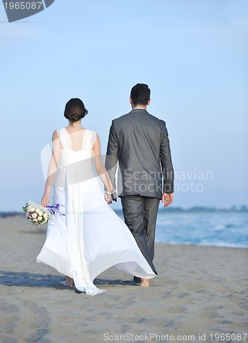 Image of romantic beach wedding at sunset