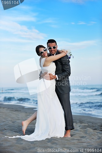 Image of romantic beach wedding at sunset