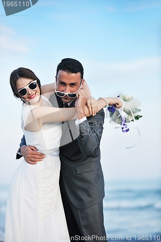 Image of romantic beach wedding at sunset