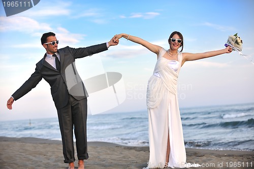 Image of romantic beach wedding at sunset