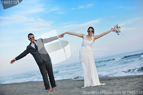 Image of romantic beach wedding at sunset