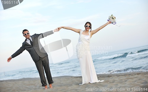 Image of romantic beach wedding at sunset