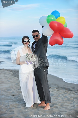 Image of romantic beach wedding at sunset