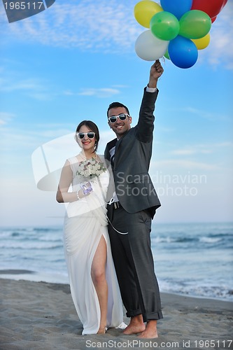 Image of romantic beach wedding at sunset