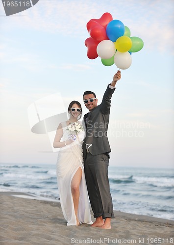 Image of romantic beach wedding at sunset