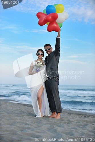 Image of romantic beach wedding at sunset