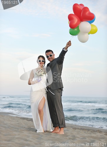 Image of romantic beach wedding at sunset