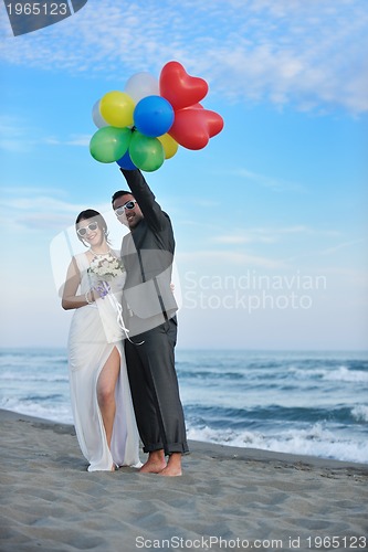 Image of romantic beach wedding at sunset