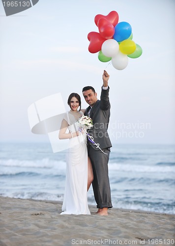 Image of romantic beach wedding at sunset