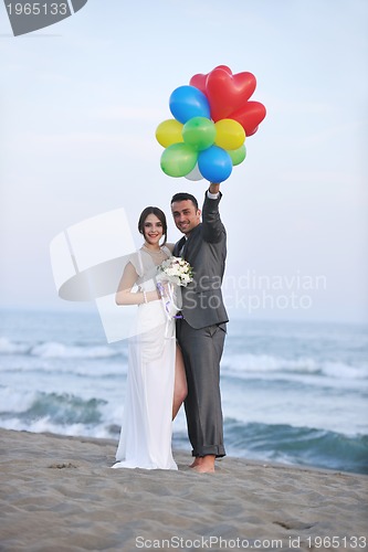 Image of romantic beach wedding at sunset