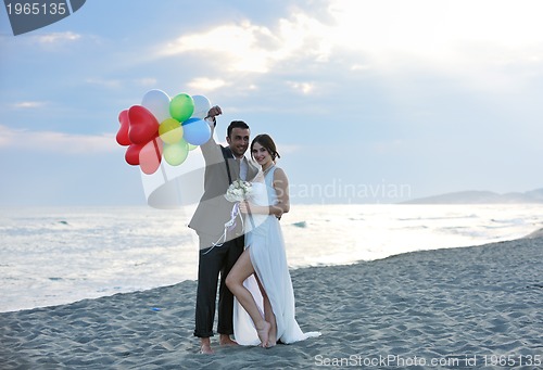 Image of romantic beach wedding at sunset