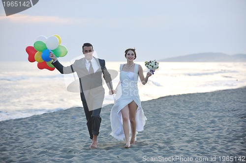 Image of romantic beach wedding at sunset