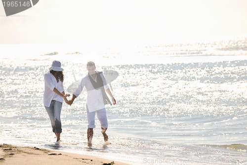Image of happy young couple have fun at beautiful beach