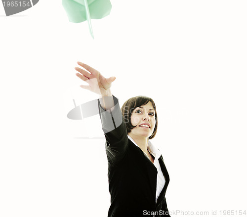 Image of business woman throwing  paper airplane
