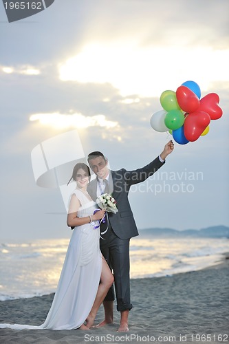 Image of romantic beach wedding at sunset